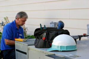 HVAC-technician-hard-at-work-on-an-air-conditioner