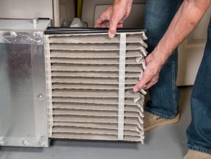 person-changing-HVAC-air-filter